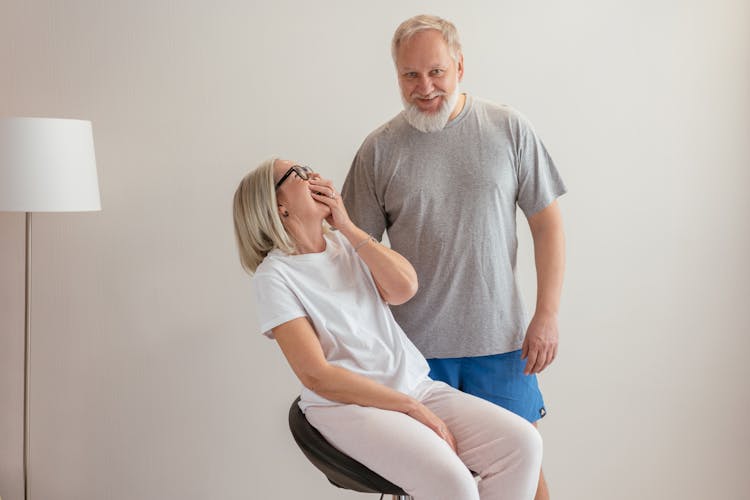 A Woman Laughing While Sitting Next To Her Partner