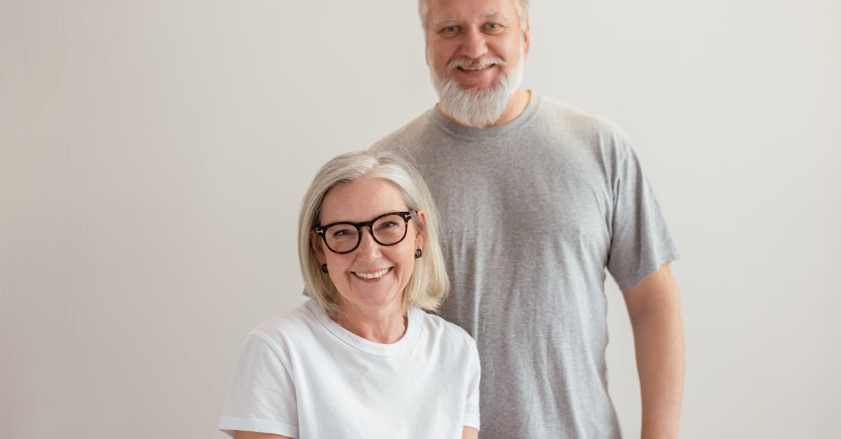 Cheerful senior couple smiling indoors, capturing a warm and happy moment together.