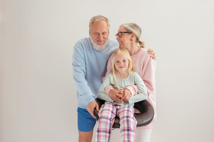 An Elderly Couple Together With Their Grandchild