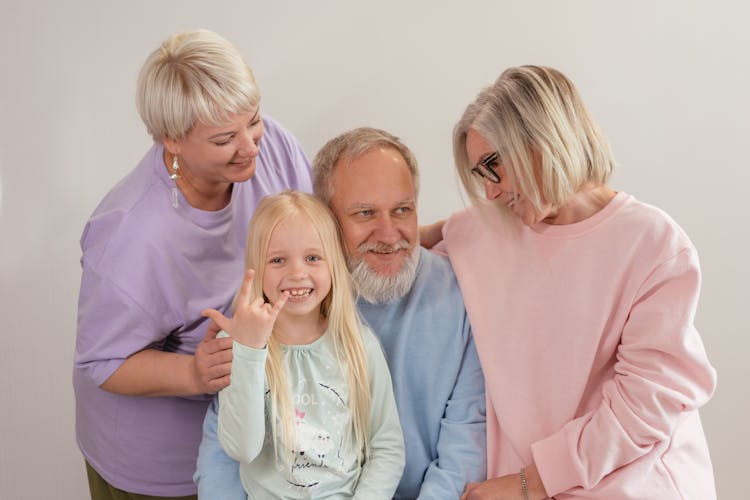 A Family Wearing Long Sleeve Shirts In Pastel Colors