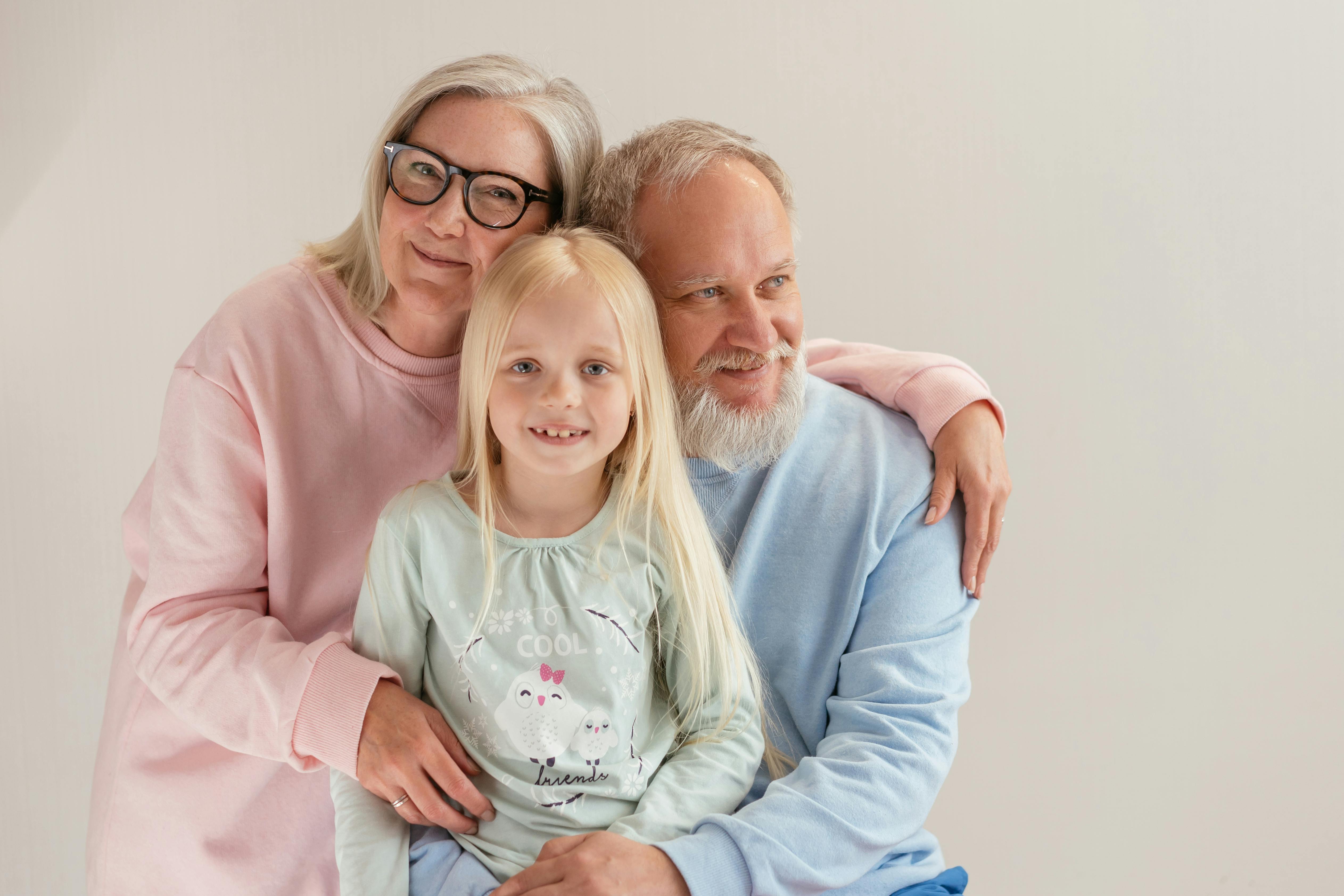 an elderly couple together with their granddaughter