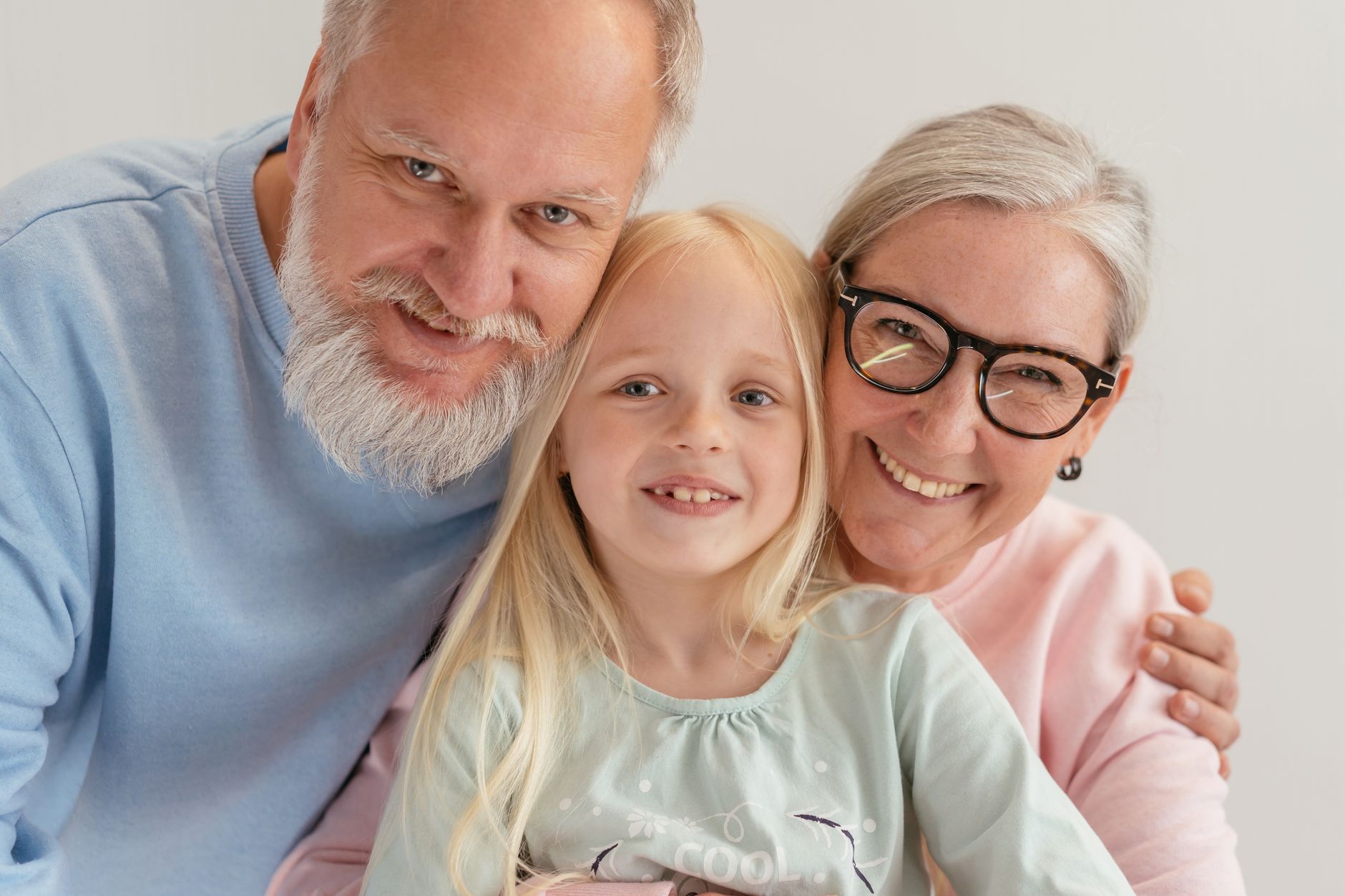 Adult child sitting with elderly parent reviewing legal guardianship documents at kitchen table