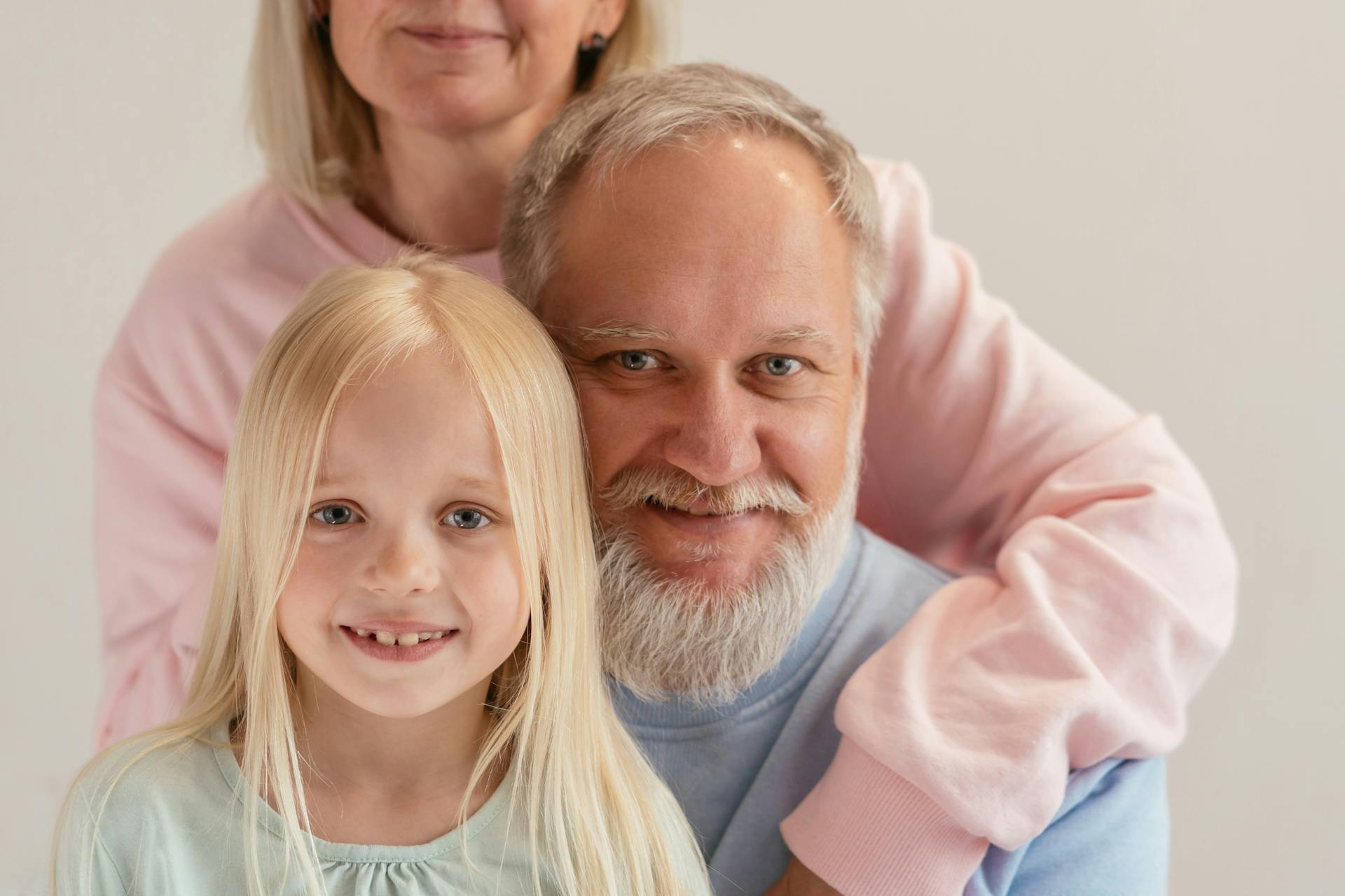 An Elderly Man Smiling with His Grandchild