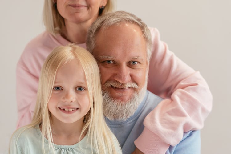 An Elderly Man Smiling With His Grandchild