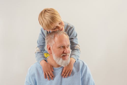 A Young Boy Embracing His Grandfather