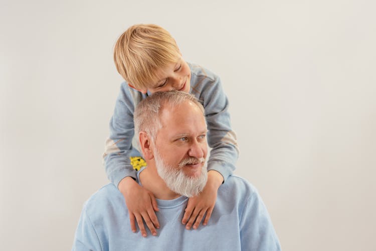 A Young Boy Embracing His Grandfather