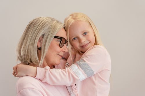 Free Senior woman and young girl sharing a warm embrace, expressing love and companionship. Stock Photo
