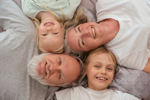 Free Grandparents and Their Grandchildren on the Floor Stock Photo