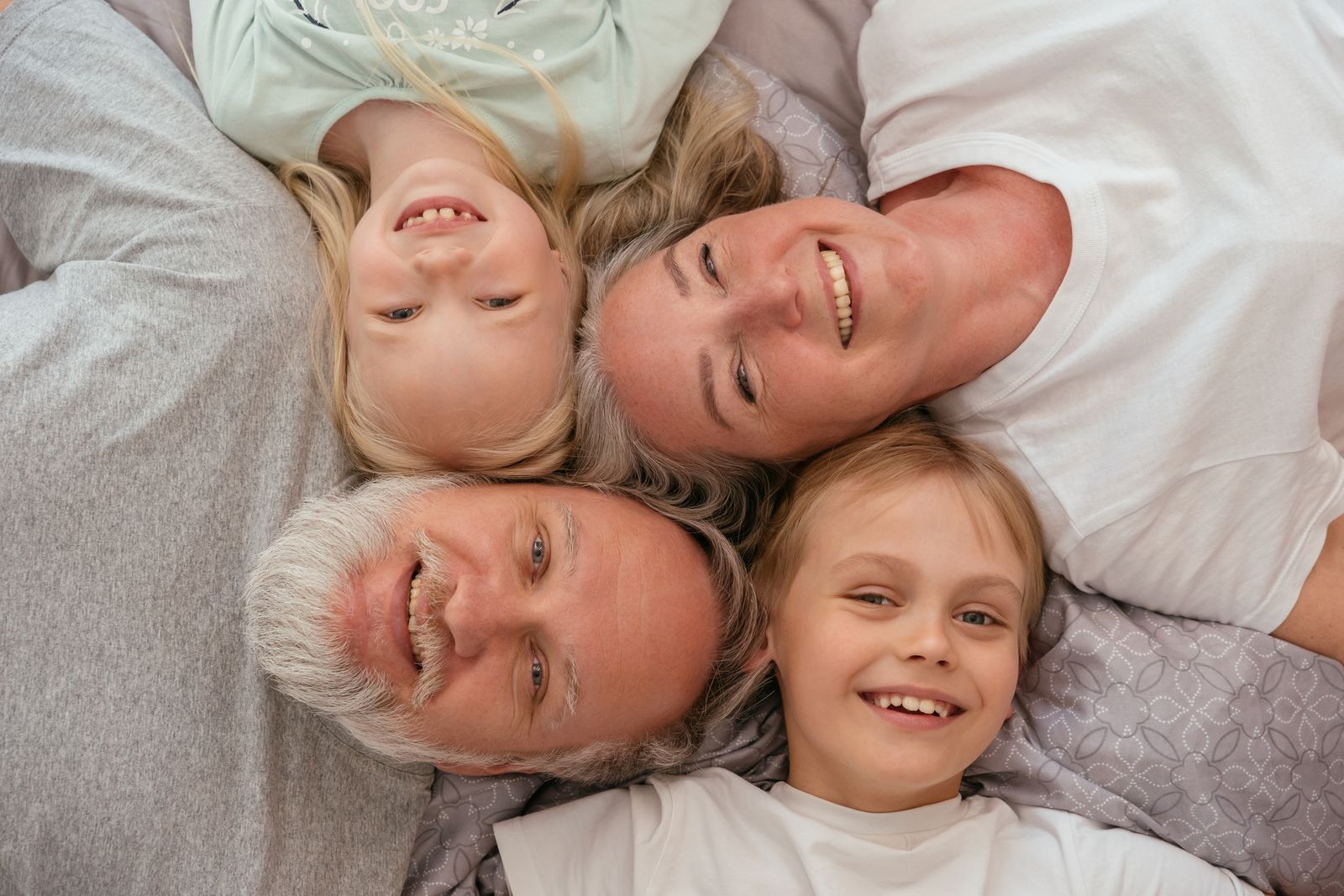 Grandparents and grandchildren together, spanning generations.