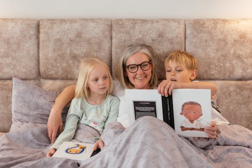 Free Grandmother Reading a Book for the Kids Stock Photo