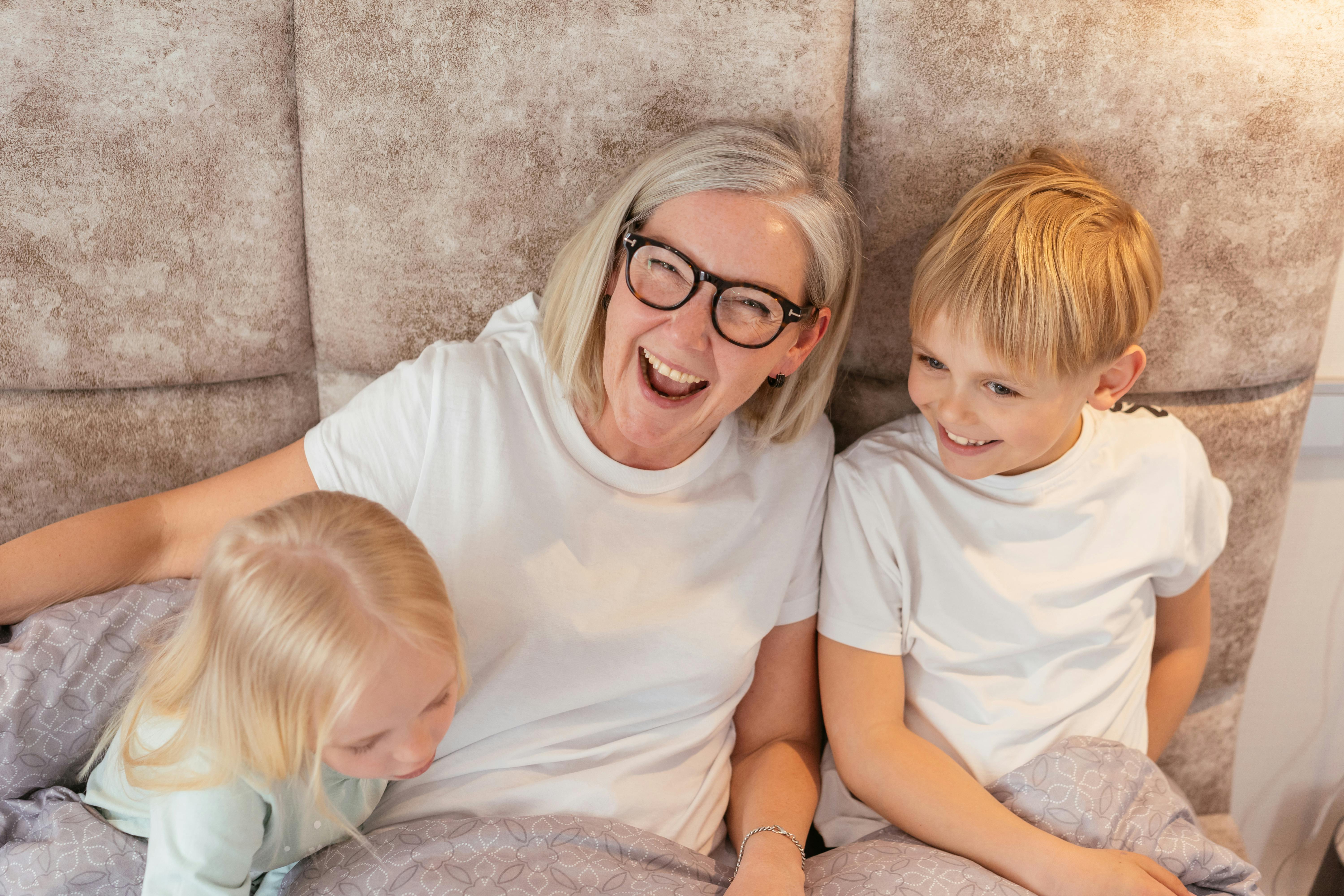 Grandmother laughing with grandchildren together
