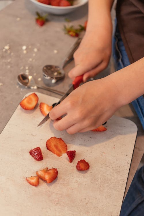 A Person Slicing a Strawberry