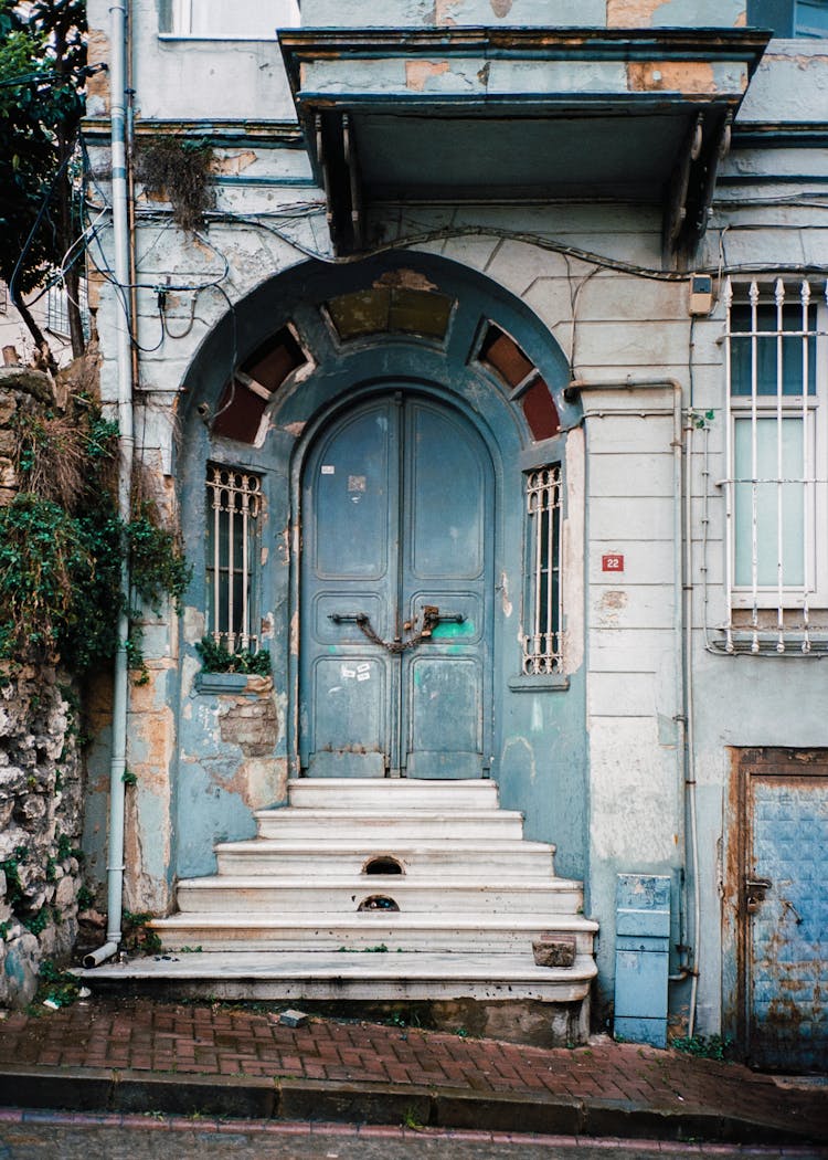 An Abandoned House With Front Stoop Near The Street