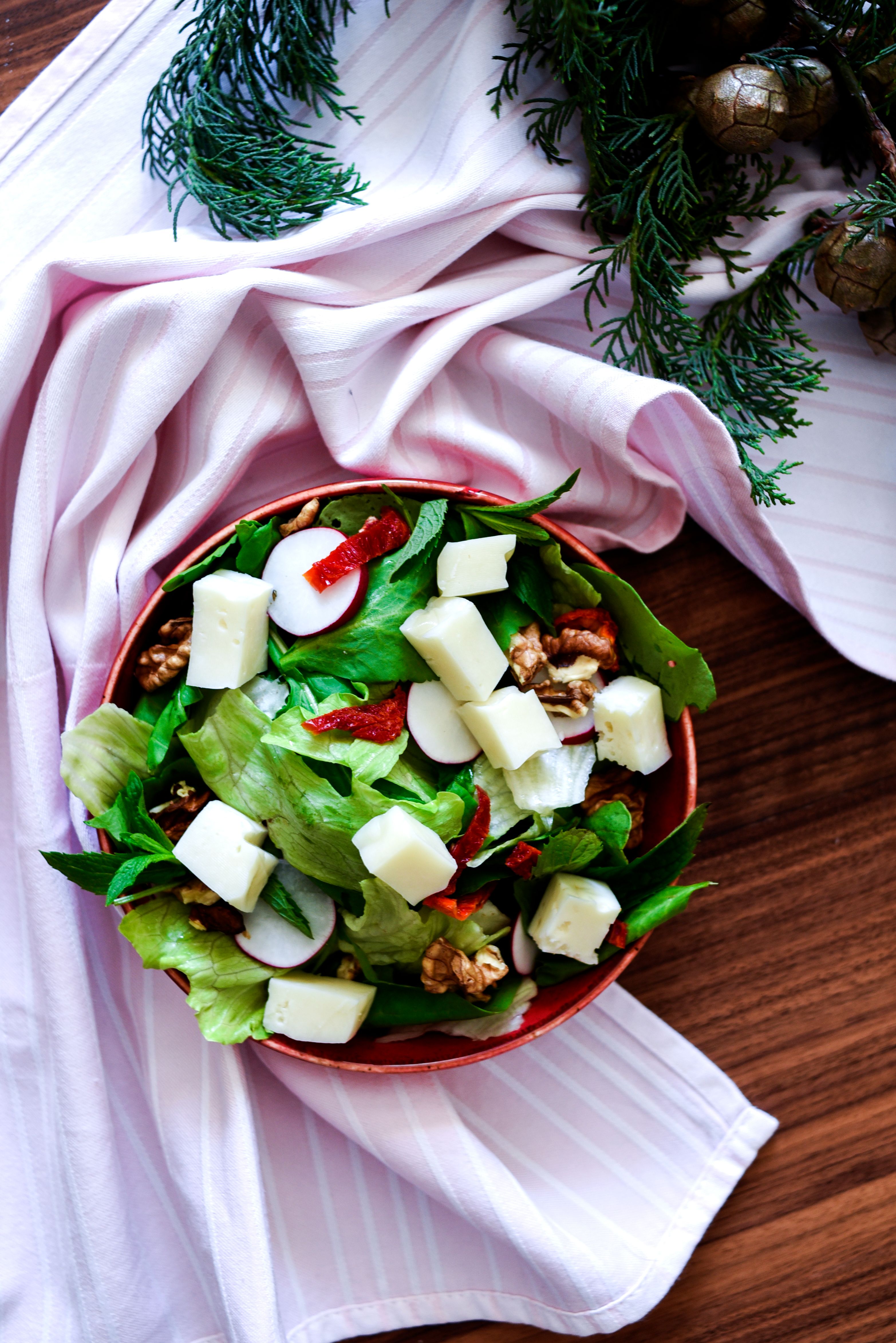 Top view of a delicious fresh cheese salad with lettuce, walnuts, and radish in Turkey.