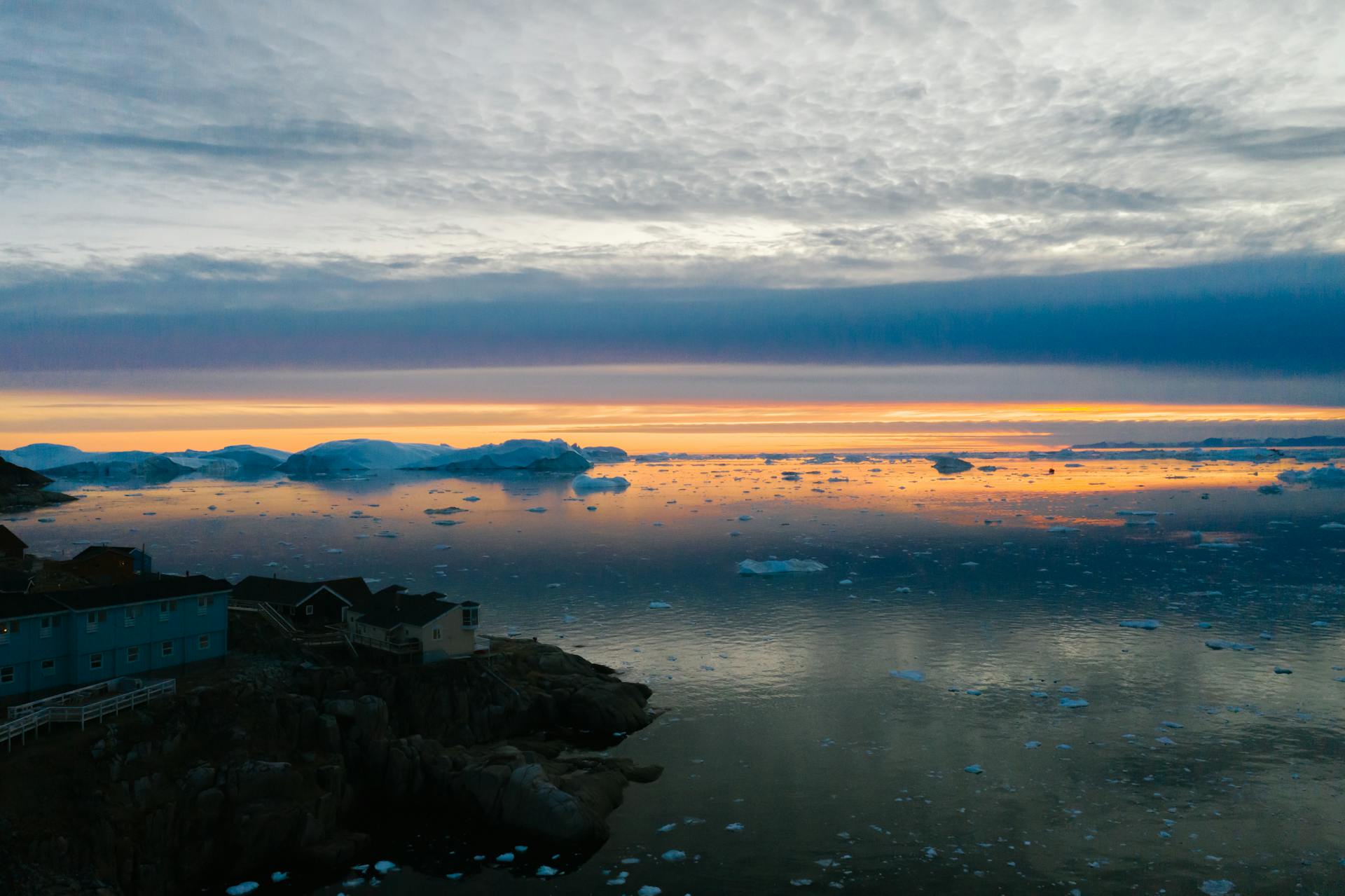 Village on Sea Shore in Winter at Sunset