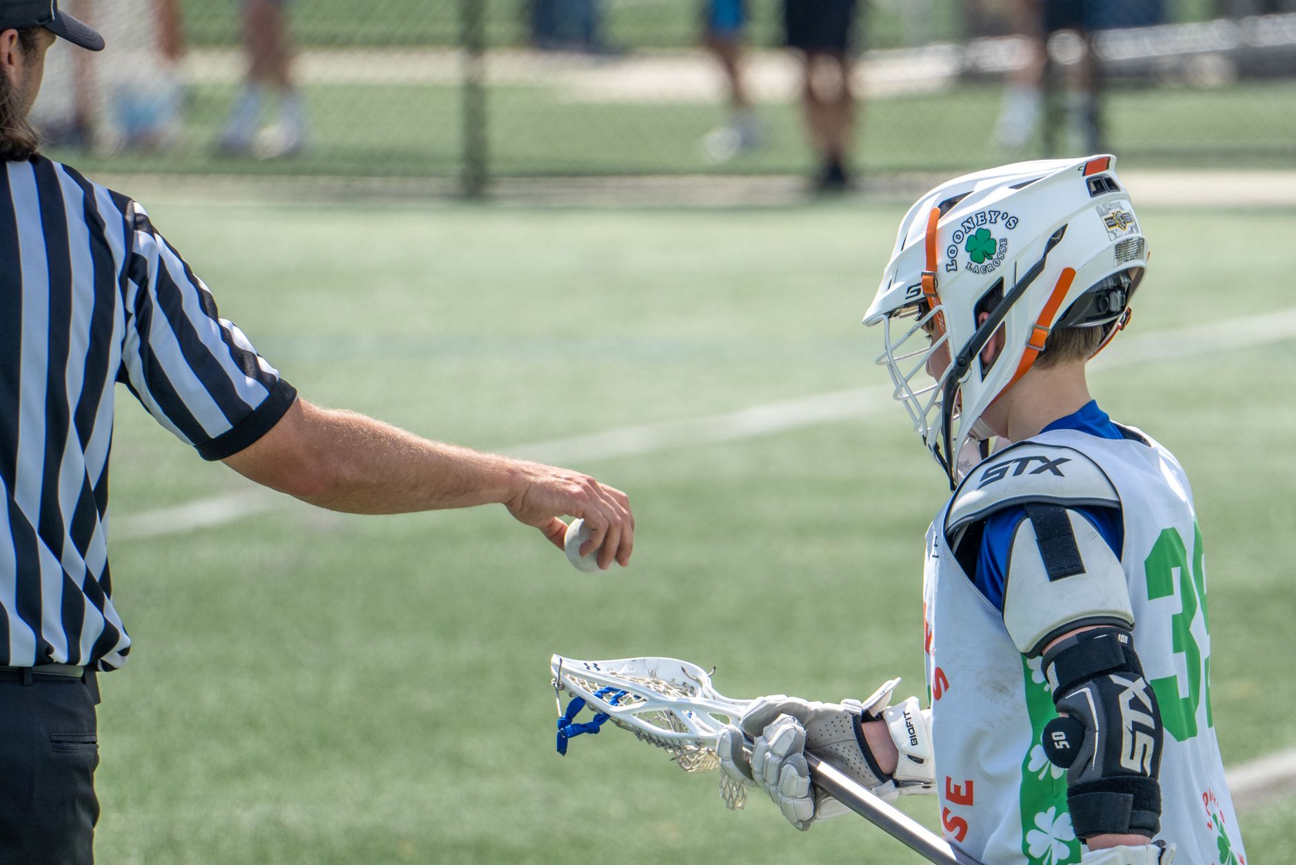A young lacrosse player interacts with a referee during a game in Columbia, MD.