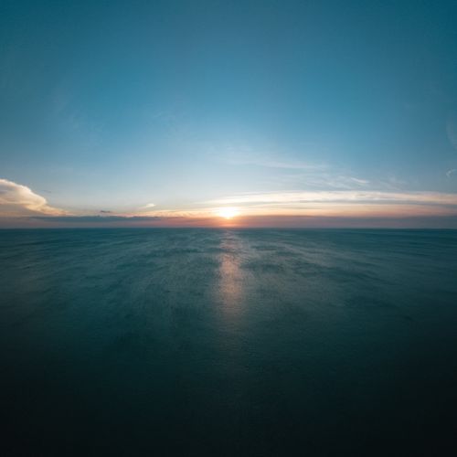 Sunrise over open water from the air. Photo by Josh Sorenson on Pexels