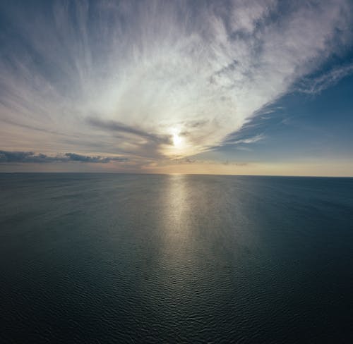 Aerial View of Body of Water during Sunrise