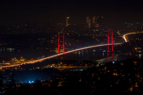 Free A stunning night view of the illuminated Bosphorus Bridge in Istanbul, showcasing vibrant city lights. Stock Photo