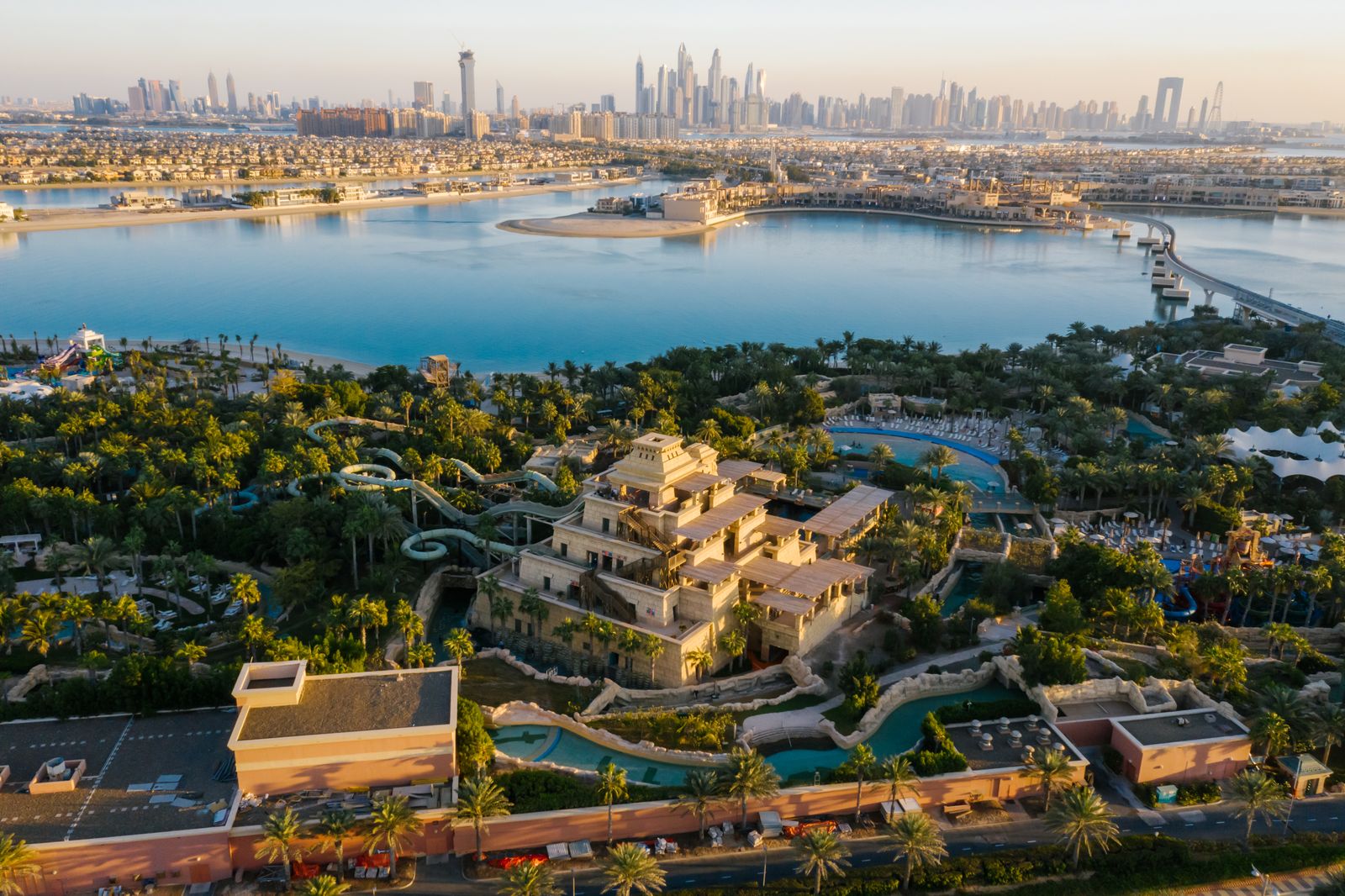 Aerial view of Aquaventure's water slides and tower on Palm Jumeirah, with Dubai Marina beyond