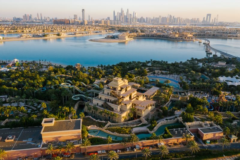 Aerial view of Aquaventure's water slides and tower on Palm Jumeirah, with Dubai Marina beyond