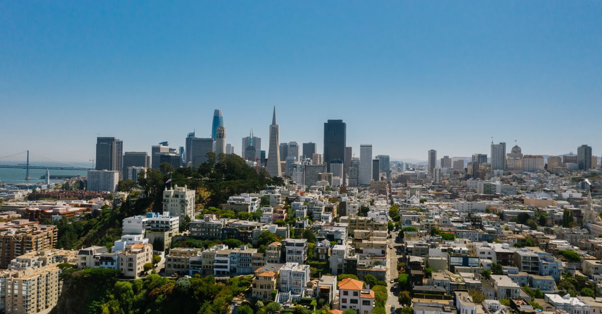 Stunning aerial photo capturing San Francisco's skyline under a clear blue sky, highlighting iconic landmarks and urban landscape.