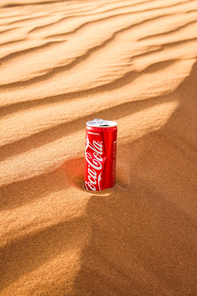 A Can Of Soda On The Sand 