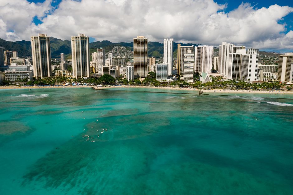Ultimate 30 Minutes SHARED Helicopter Tour in Honolulu Review: Your Complete Guide to This Incredible Oahu Flight Review 2026 - A beautiful aerial view of Honolulu's skyscrapers lining the coastline with turquoise ocean waters.