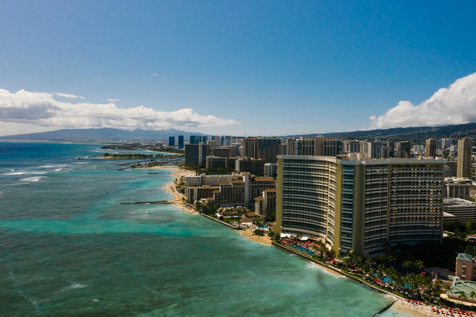 Ultimate Exclusive Landing with Spectacular Big Island Helicopter Tour Review Review 2026 - Stunning aerial view of Honolulu's coastline with skyscrapers and turquoise waters.