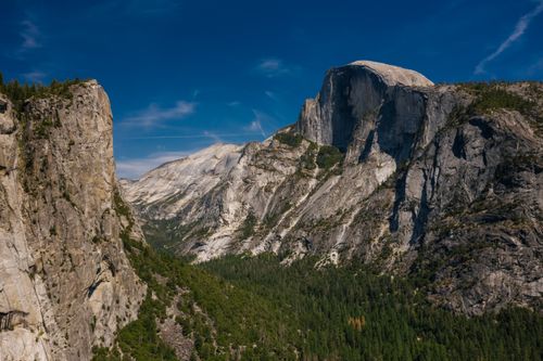 Free Breathtaking view of Half Dome in Yosemite with clear blue sky and lush greenery. Stock Photo