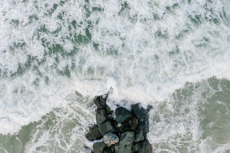 Wave Around Rocks On Sea Shore