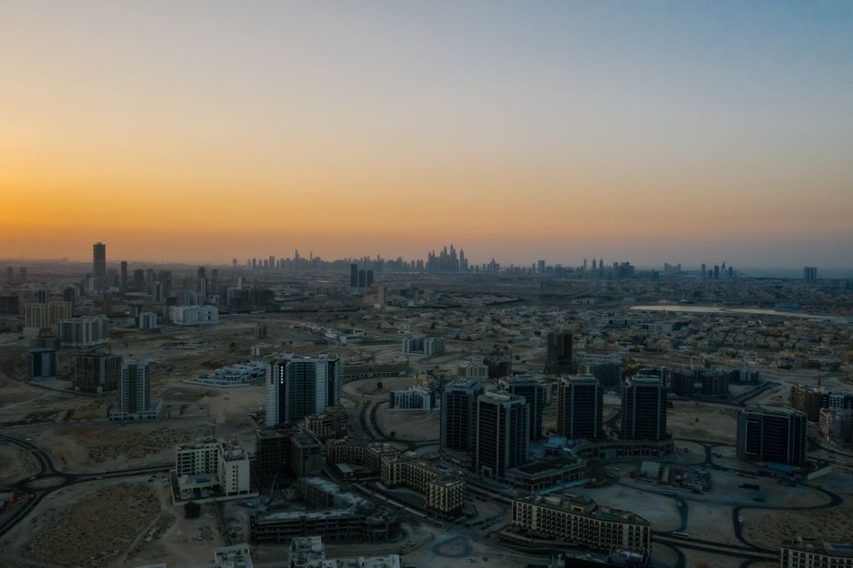 Incredible Private: Ultimate Dubai Helicopter Tour with Optional Transfers Review Review 2026 - Stunning aerial view of Dubai cityscape at dawn with a warm skyline.