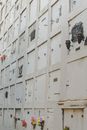 Full frame view of columbarium wall of white stone color with flowers on cemetery