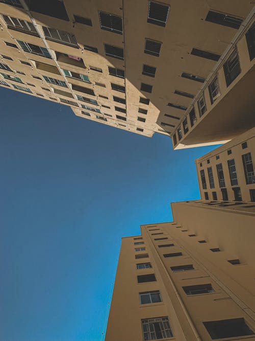 Free Skyscrapers with yellow walls on background of blue sky Stock Photo