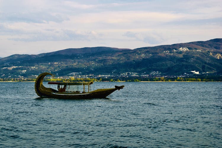 Viking Boat On A Lake And Hills In Background