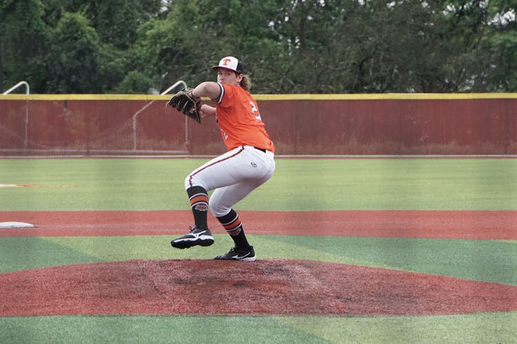 A Man In Orange Jersey Shirt Playing Baseball