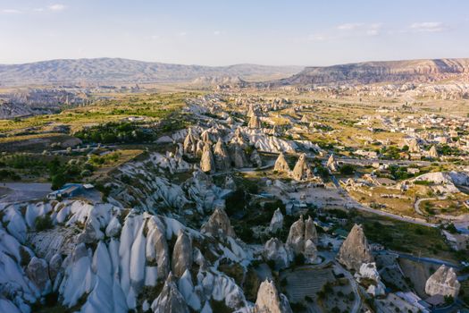 Discover Cappadocia's stunning natural rock formations from above, showcasing Turkey's iconic landscape.