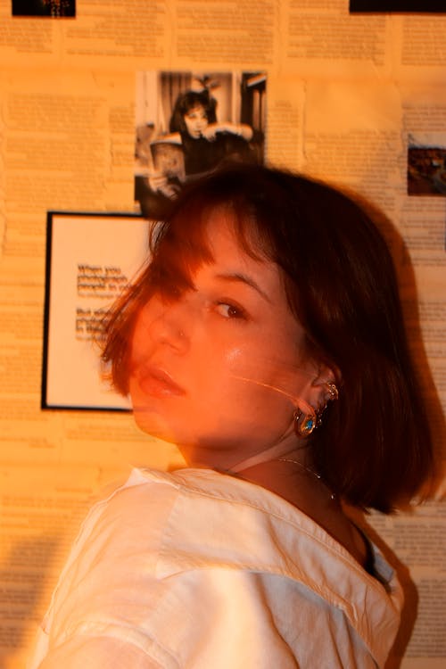 A Woman in White Shirt Looking Over Shoulder