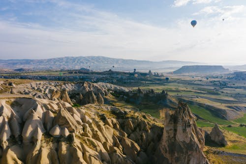 Rock Formations and Hot Air Balloon Flying over Cappadocia