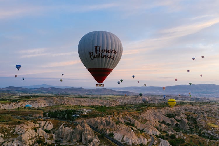 Hot Air Balloon Flying Over Vast Land