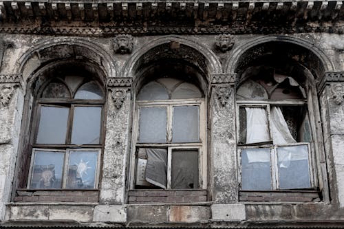 A Low Angle Shot of an Abandoned Building with Glass Windows