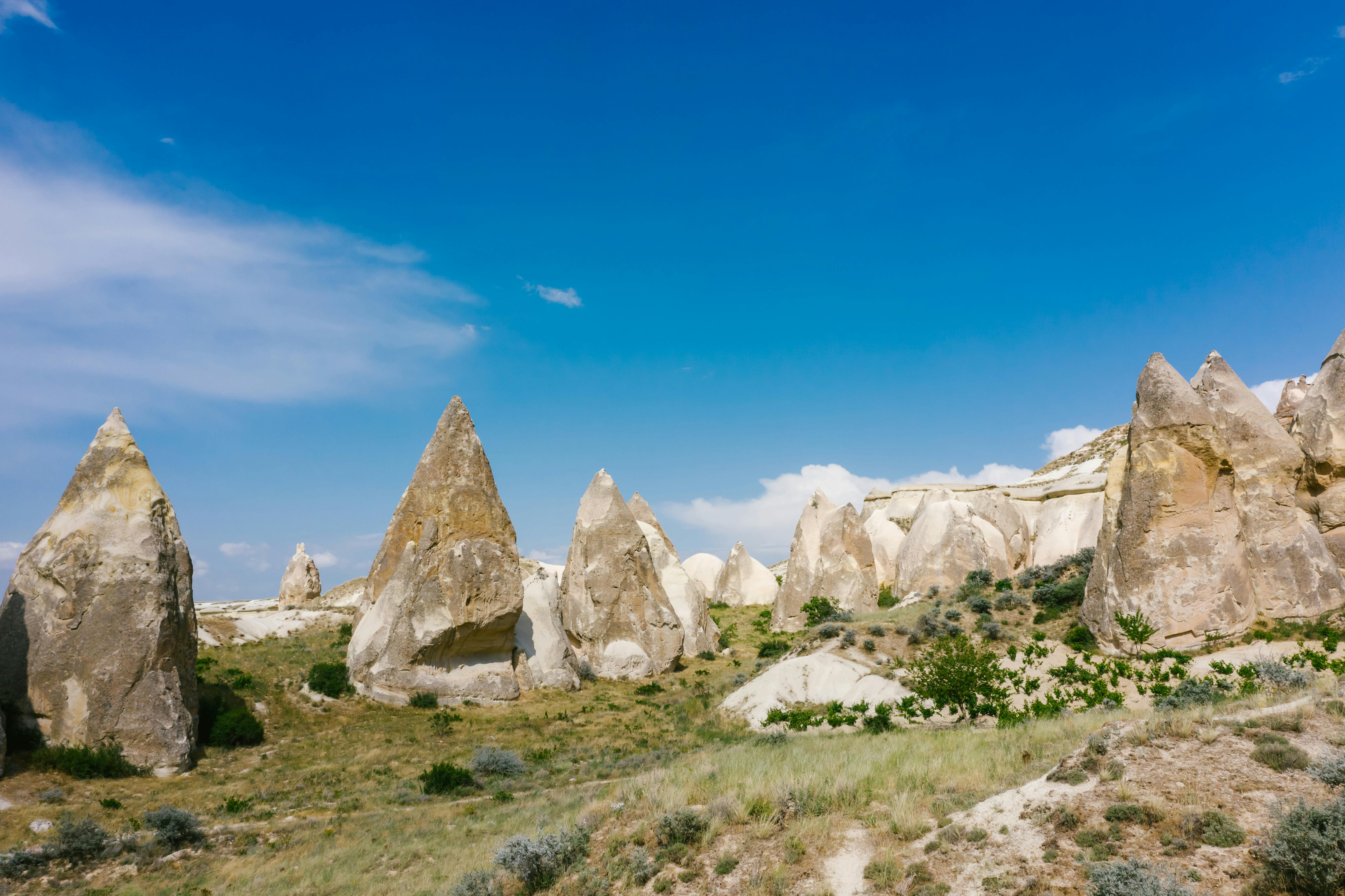 Cone Shaped Rock Formations under a Blue Sky · Free Stock Photo