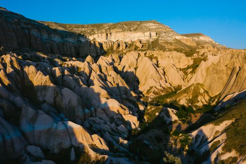 Free Explore the scenic beauty and tranquility of the unique rock formations in Cappadocia at sunset. Stock Photo