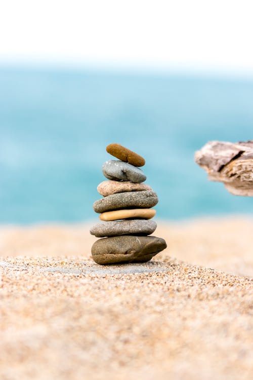 Stack of Round Stones on a Sandy Beach