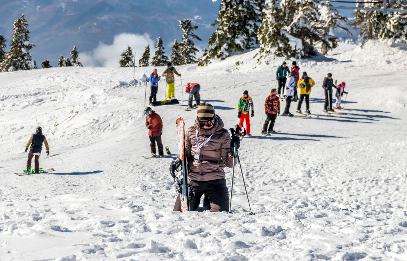 Group of skiers enjoying a sunny winter day on the snowy slopes of Bursa, Turkey.