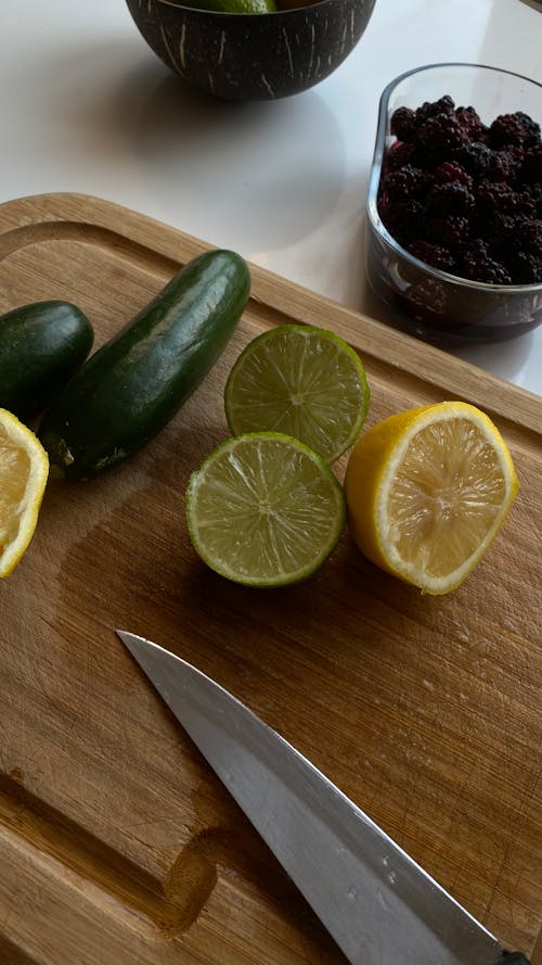 A Close-Up Shot of a Chopping Board with Sliced Lemon and Lime