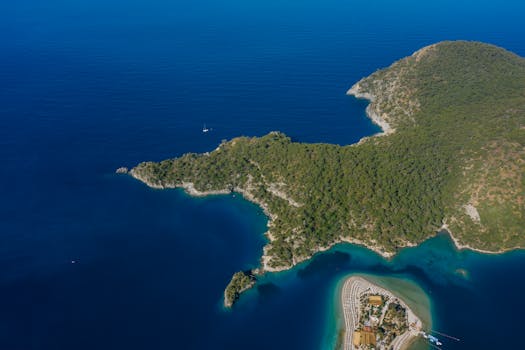 A stunning aerial view of a lush island surrounded by deep blue sea.