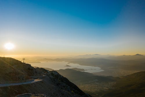 Free Aerial View of Mountains and Body of Water during Sunset Stock Photo