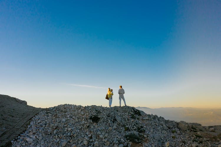 Family Looking At Sunset In Mountains