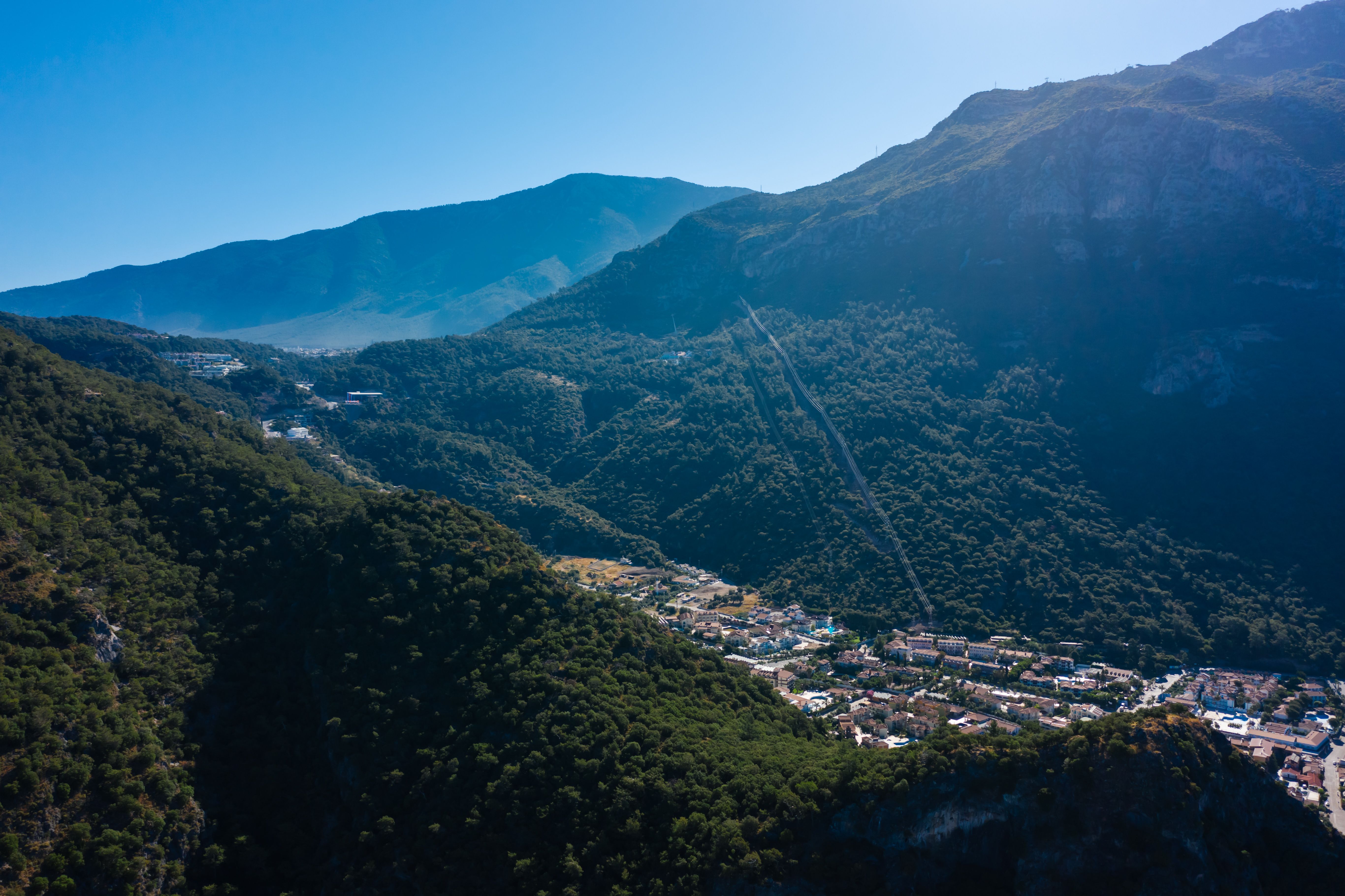 Aerial View of Green Mountains and Houses in a Valley · Free Stock Photo